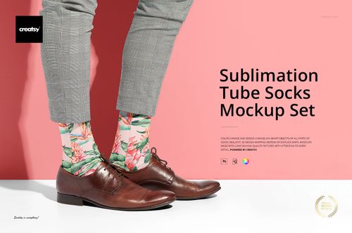 Mockup of sublimation tube socks with a tropical floral design, worn with dress shoes and gray pants against a pink backdrop.