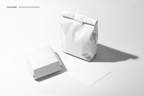 Front view of fast food packaging mockup with a white burger box, paper bag, and blank menu card on a light surface.