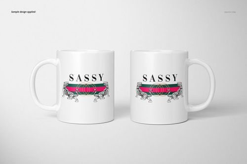 Front view of two white 11oz mugs with a bold graphic design featuring the word 'SASSY' and decorative elements.
