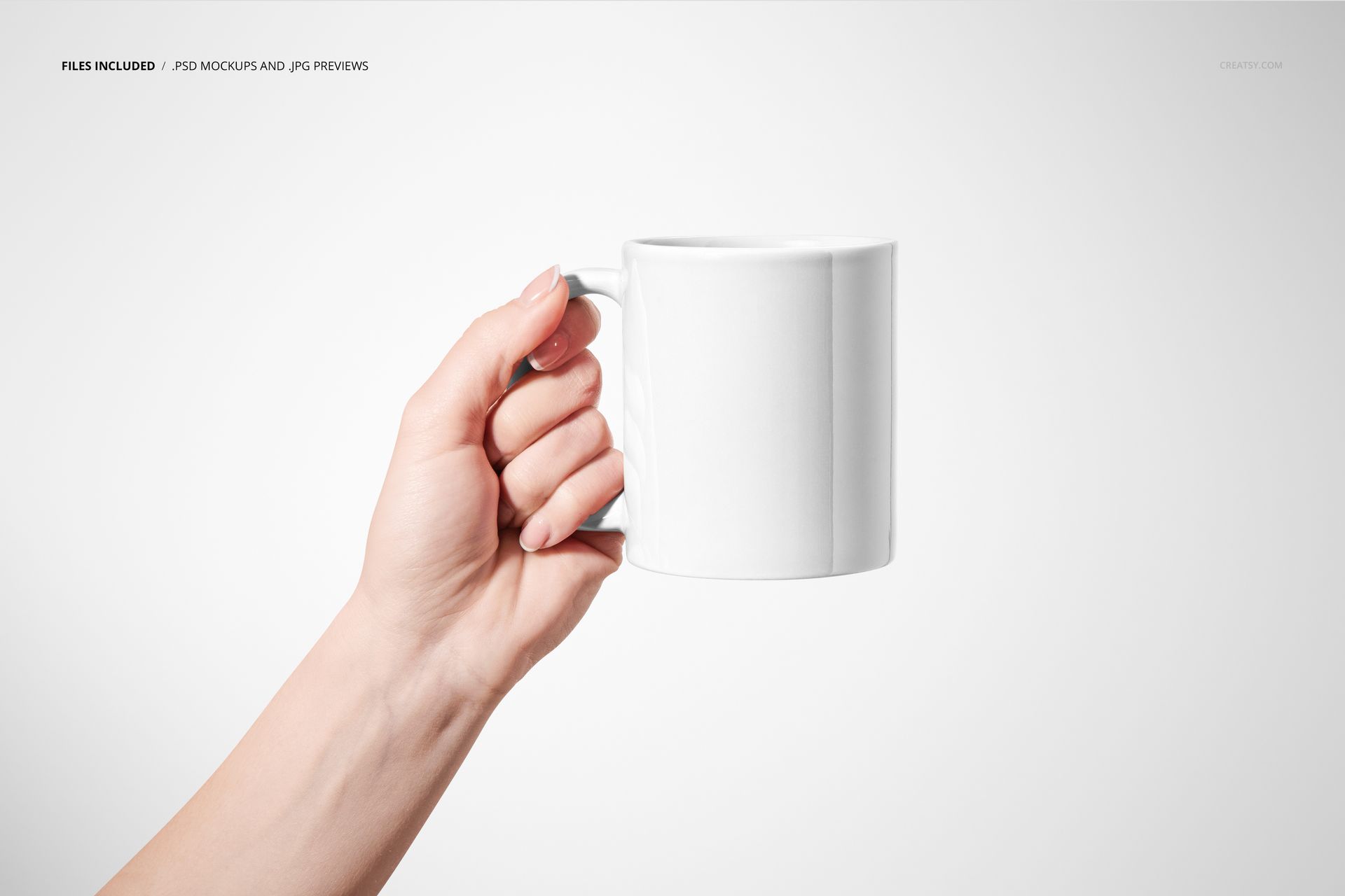 Hand holding a plain white mug against a light gray background, showcasing the mug's front side for mockup purposes.
