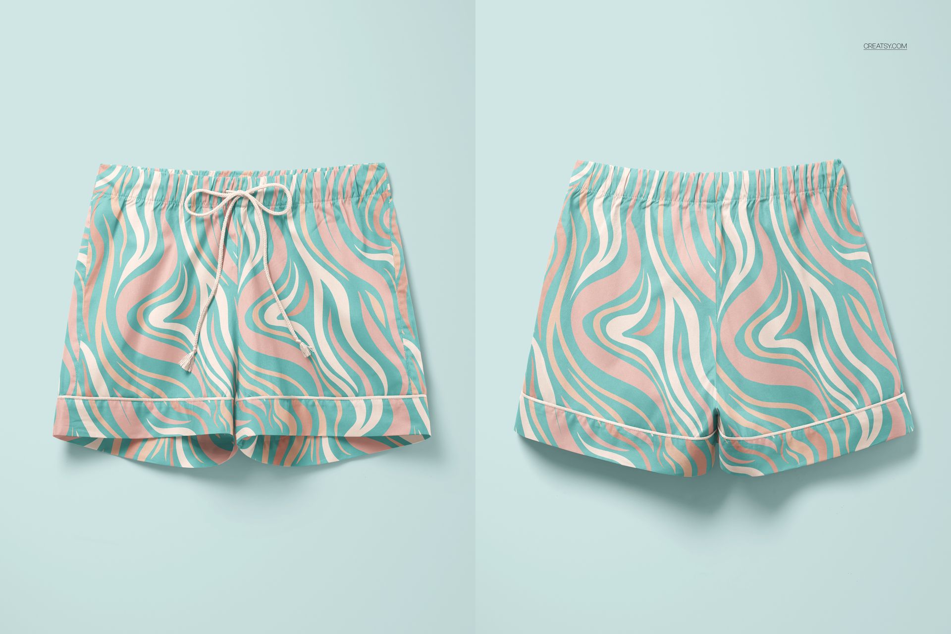 Mockup of pajama shorts featuring abstract swirl design in green, pink, and white, shown from two angles.
