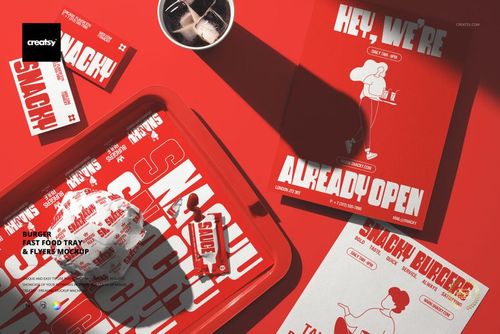 Top view of a fast food tray with burger packaging, red flyers, and utensils on a red surface in a mockup scene.