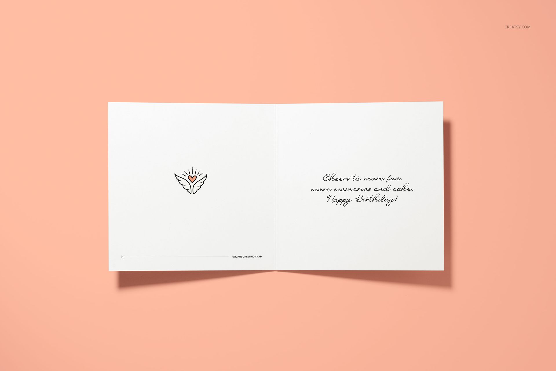 Square folded greeting card mockup displayed open on a peach background, showing minimal artwork and handwritten text.