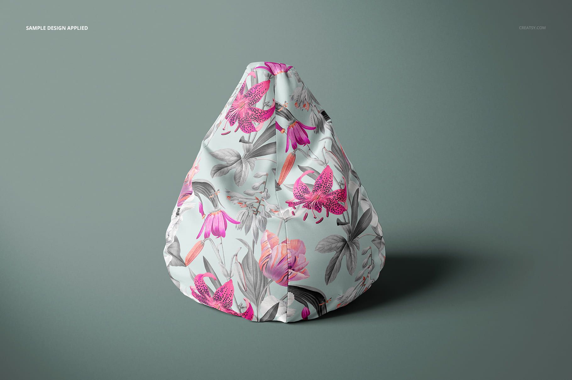 Front view of a bean bag chair mockup featuring a botanical pattern in shades of pink, gray, and white on a neutral surface.