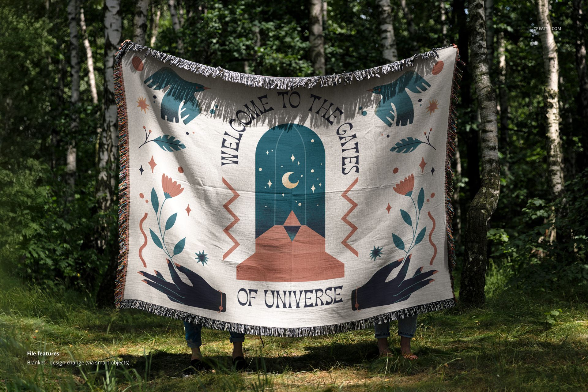 Front view of a jacquard fringed throw blanket mockup featuring a bold graphic pattern, held outdoors among trees.