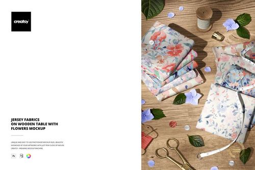 Jersey fabric mockup featuring pastel floral prints, displayed on a wooden surface with scattered petals and sewing accessories.