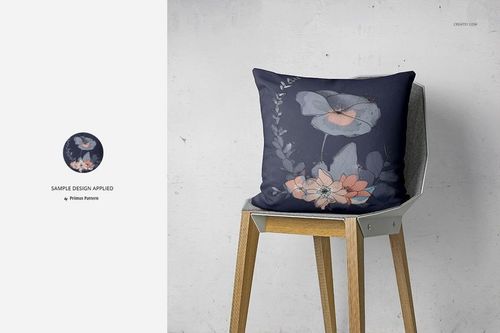 PSD mockup of a decorative pillow featuring a navy background with soft floral design, positioned on a light wood chair.