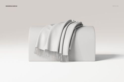 Draped throw blanket in light gray with fringed edges displayed on a curved white surface, front view.