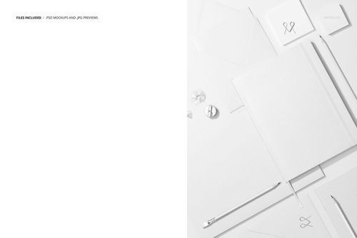 Top view of a stationery set mockup featuring a planner, notebooks, envelopes, and pens arranged on a white surface.