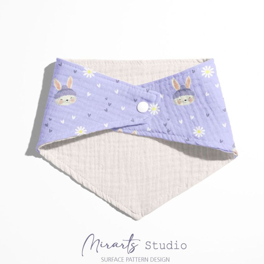 Baby muslin bandana mockup featuring a light purple fabric with cute rabbit faces and small white flowers on a white background.