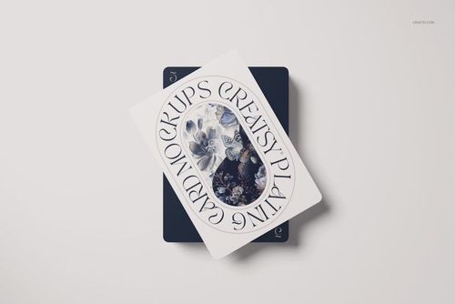 Playing cards mockup showing a card with ornate floral pattern and circular text overlay, placed on another dark card.