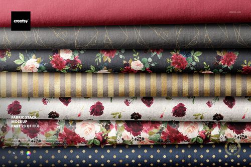 Fabric stack PSD mockup with multiple textile layers in red, gray, and cream, decorated with flowers and patterns.