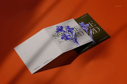 Square greeting card mockup set displayed on an orange surface, showing two cards with floral artwork and folded edges.