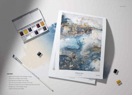 Art paper mockup with abstract painting, watercolor pans, and brush arranged on a light background with paint traces.
