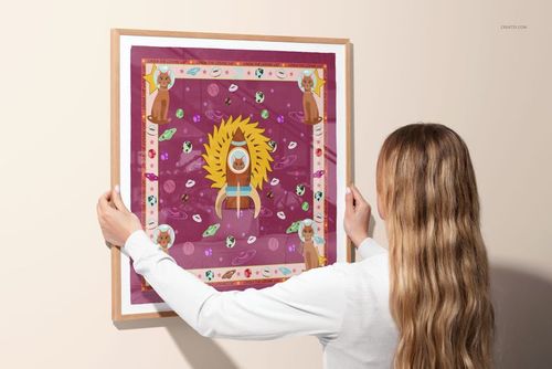 Framed silk scarf mockup showing a colorful design with central yellow motif and decorative border, held against a wall.