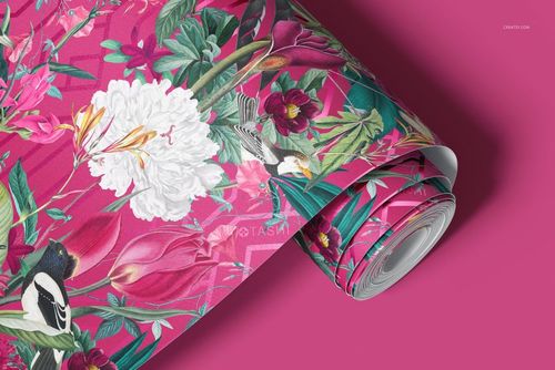 Floral paper wallpaper mockup with colorful flowers and birds, displayed partially unrolled on a solid pink surface.