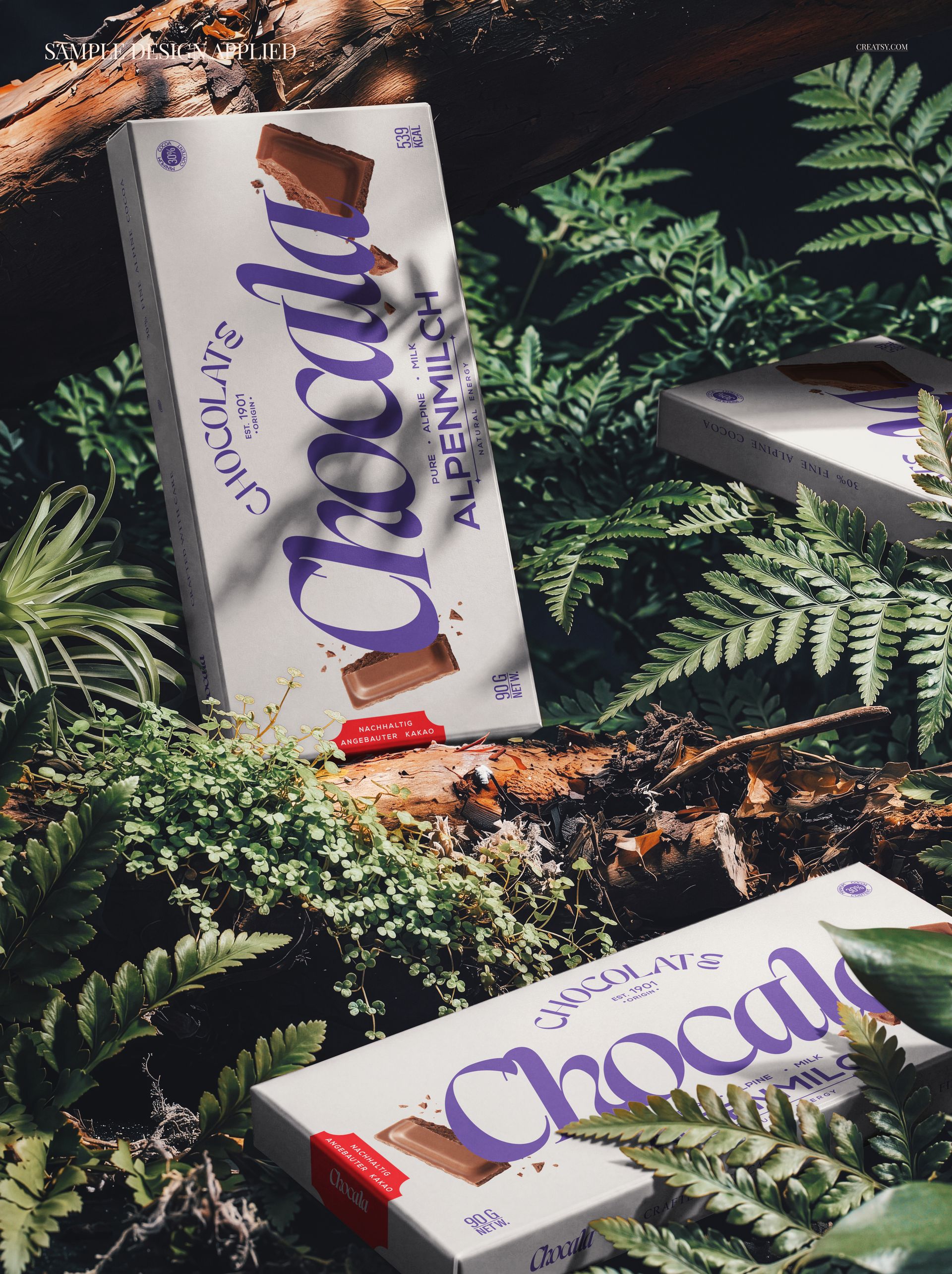 PSD mockup of chocolate packaging boxes with bold lettering, surrounded by lush foliage and natural wood.
