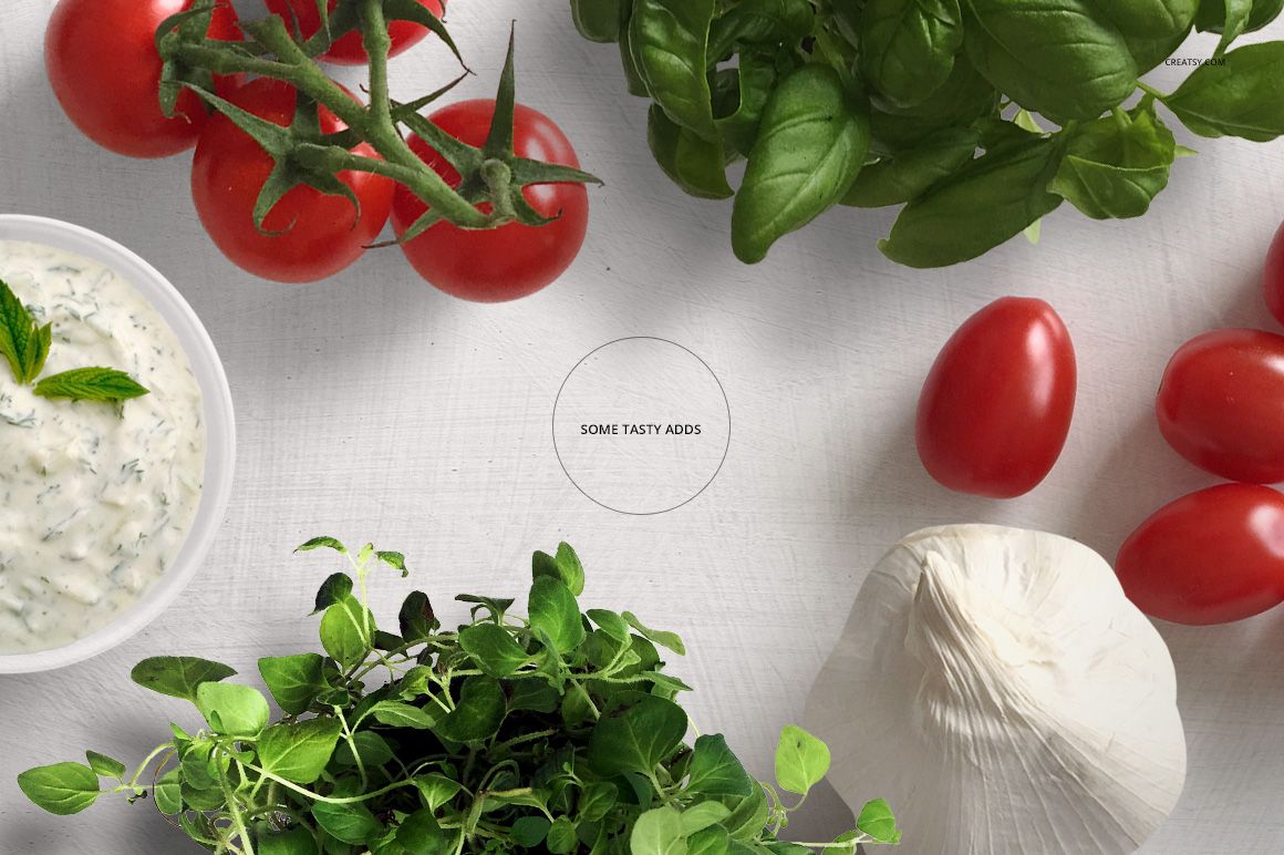 Top view of a chopping board mockup with glass center, surrounded by tomatoes, basil, tzatziki, garlic, and oregano.