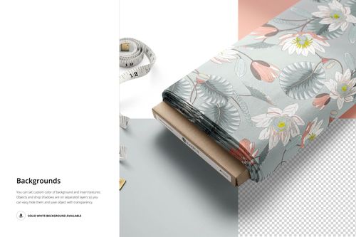 PSD mockup of a fabric bolt displaying a botanical design with lotus flowers and leaves, with measuring tape nearby.