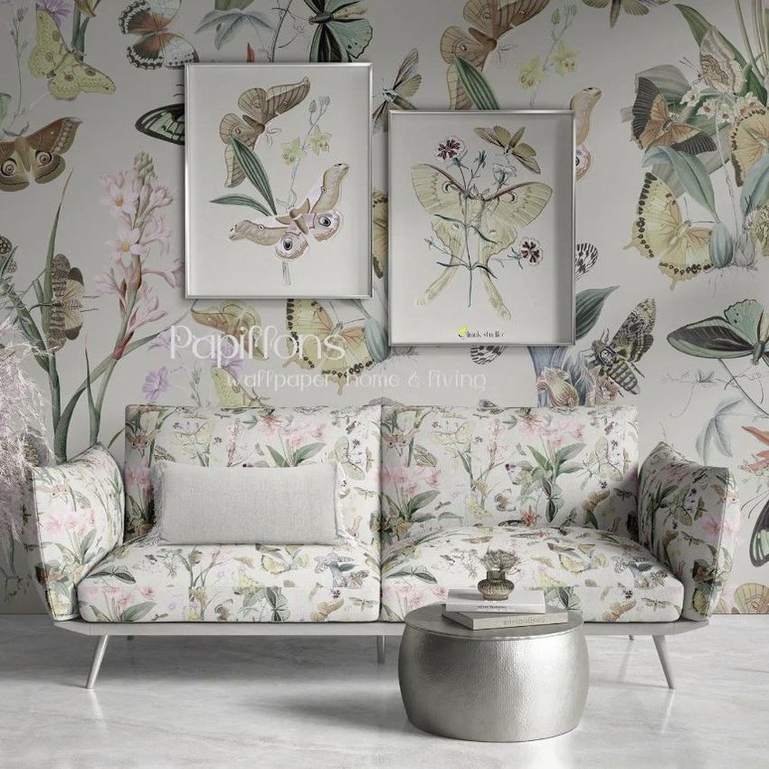 Interior scene mockup showing a patterned sofa and two framed posters against a butterfly-themed wallpaper background.