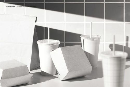 Fast food restaurant packaging mockup featuring blank burger boxes, paper bag, and drink cups on a white countertop.