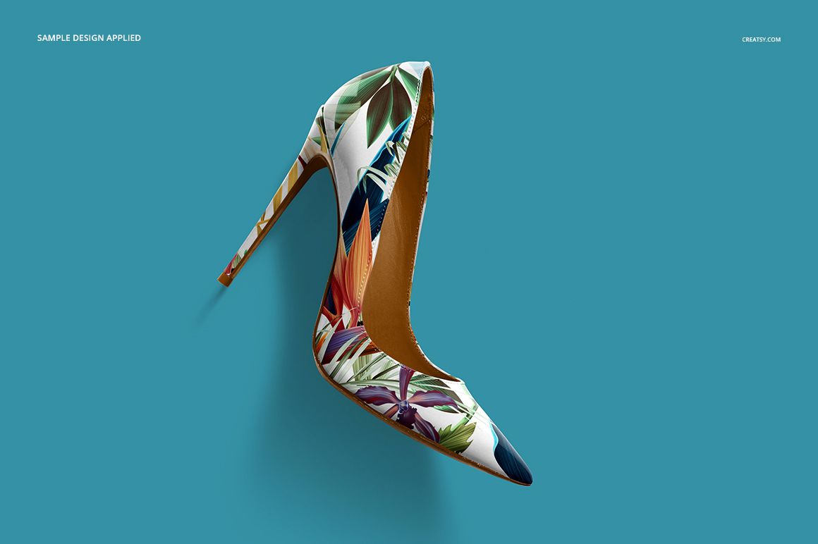 High heel shoe mockup with a pointed toe, featuring a colorful tropical leaf pattern on a blue background, top view.