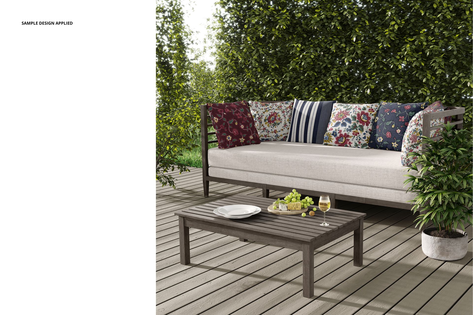 PSD mockup of a patio sofa with multiple colorful pillows, placed on a deck with greenery in the background.