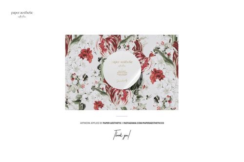 Silk scarf mockup displayed from a top view, featuring a floral pattern with red and white flowers and green leaves.