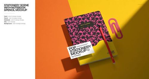 Stationery mockup featuring a notebook, pencil, card, and large paperclip arranged on a vibrant two-tone background.