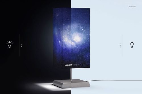 Lampshade mockup featuring a cosmic design, displayed on a square metal stand, half in shadow, half in light.