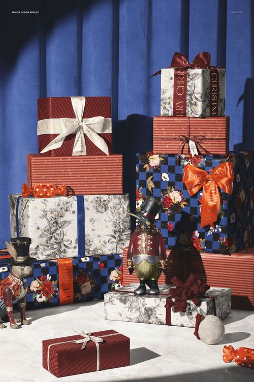 Christmas gift boxes mockup featuring wrapped presents with ribbons and festive designs, displayed on a light surface.