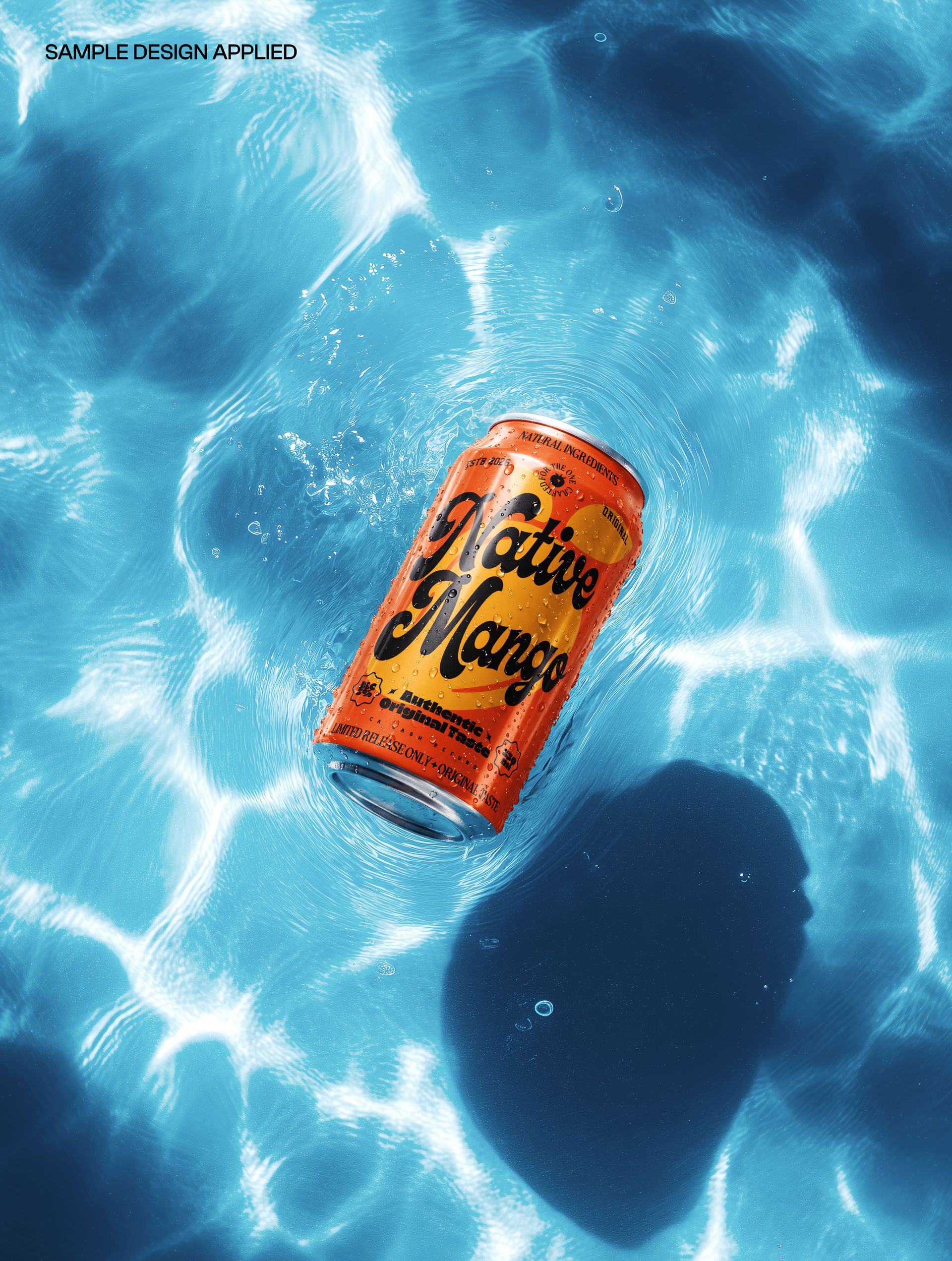 PSD mockup of a soda can with vibrant orange design drifting on sunlit water, viewed from a top perspective.
