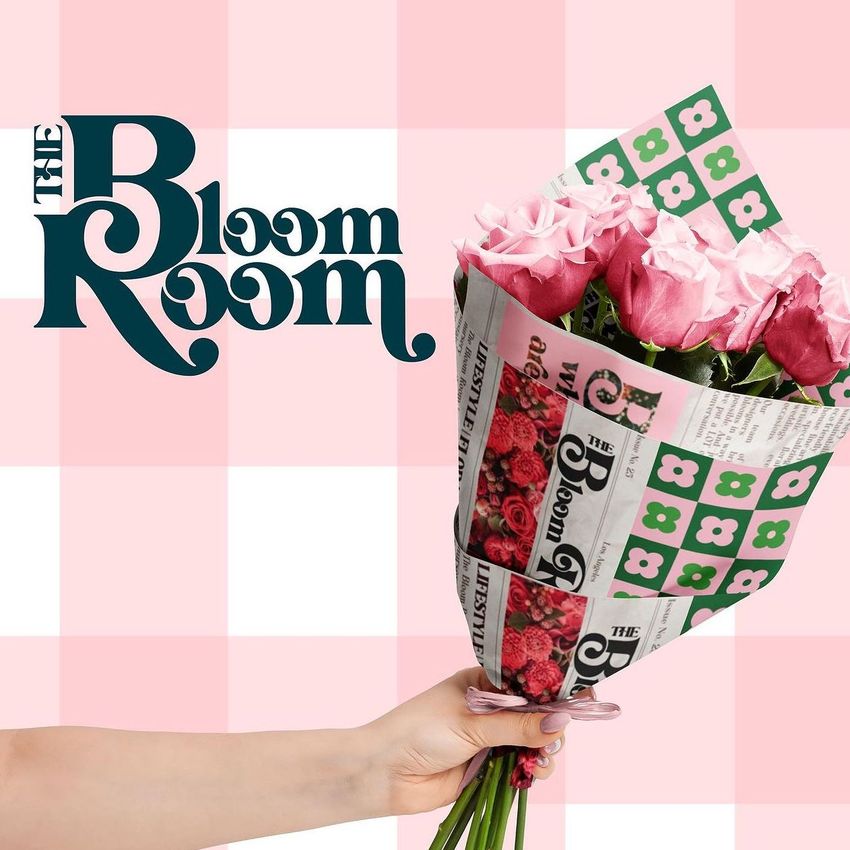 Bouquet wrapping paper mockup featuring pink roses in decorative paper with floral images and bold text on a pink checkered background.