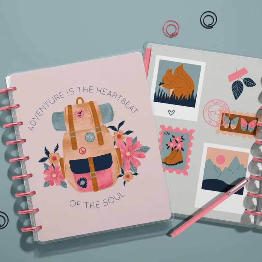 Two spiral-bound planner mockups seen from above, featuring pastel colors, adventure-themed artwork, and decorative stationery props.