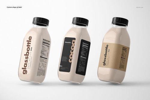 Glass bottle PSD mockup set featuring three bottles with various label styles and black screw caps, arranged side by side.