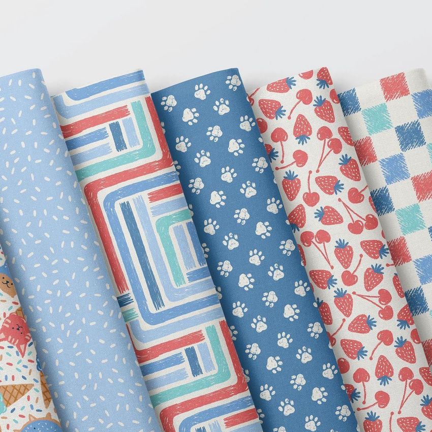Folded fabrics mockup featuring six patterned fabric pieces arranged side by side on a white background, viewed from above.