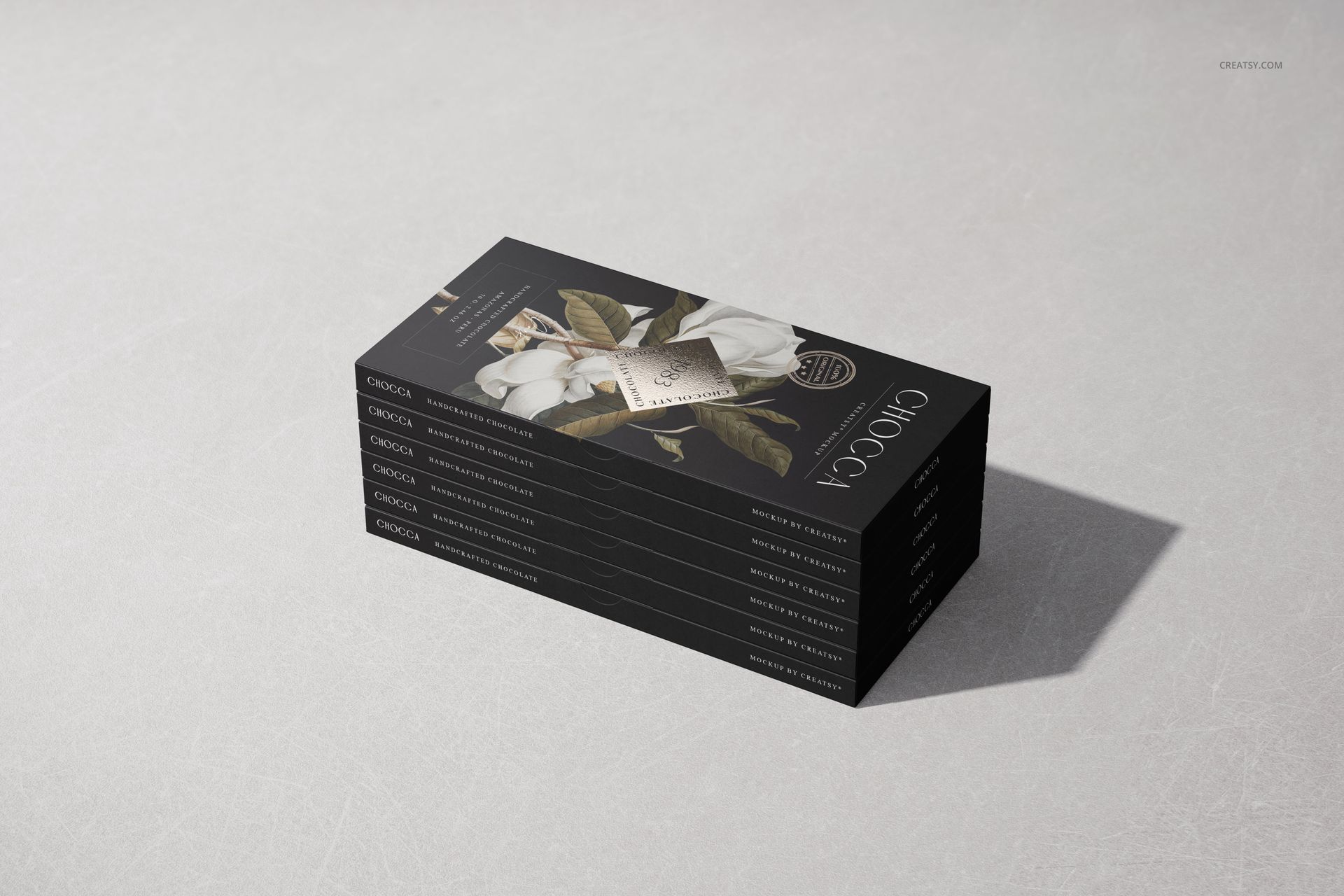 Chocolate bar packaging mockup set showing multiple bars in black wrappers with flower illustration, angled side view.