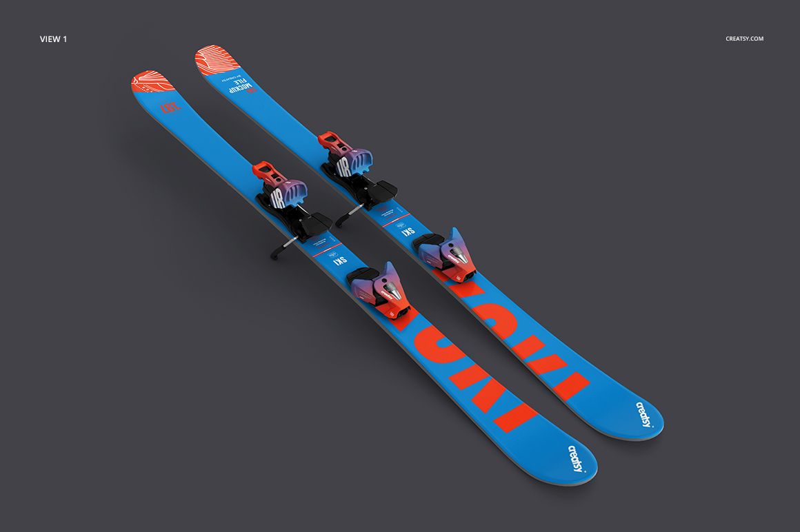 Pair of blue skis with orange accents and bindings, displayed at an angle on a dark gray background in a mockup.