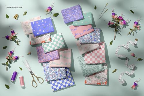 Floral scene jersey fabrics mockup showing patterned cloths in various colors, styled with tape measure and sewing accessories.