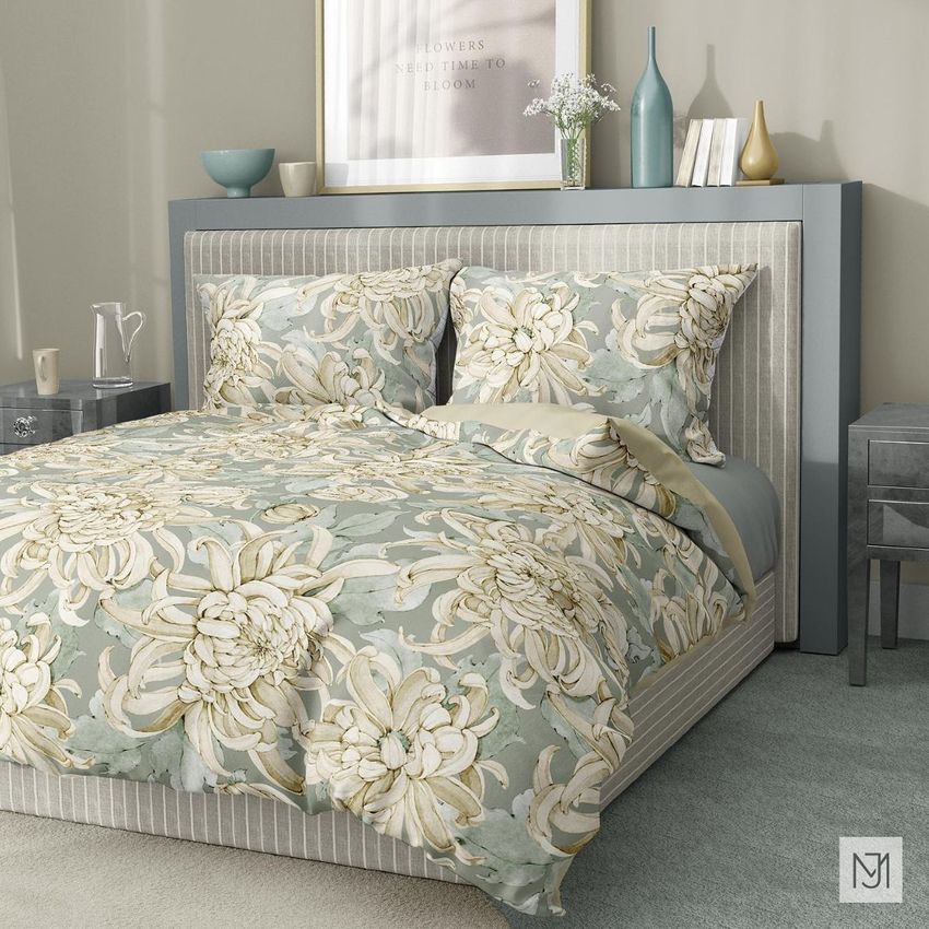 Bedding mockup showing a made bed with large chrysanthemum floral patterns in muted green and cream tones, styled in a modern bedroom.