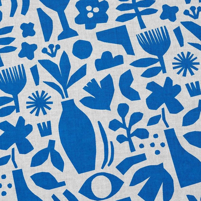 Cotton fabric mockup featuring abstract blue floral and geometric shapes on a light textured background, viewed from above.