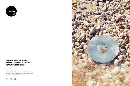 Vinyl record mockup placed on a rocky shoreline, partially wet with seawater and surrounded by small stones.