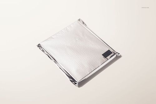 Closed hardcover book mockup with a silver metallic cover, viewed from above on a light neutral background.