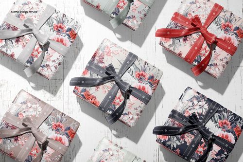 Top-down view of several gift boxes with decorative floral paper and different colored bows, shown in a PSD mockup scene.