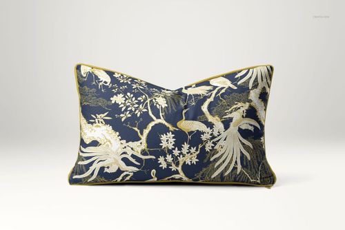 Front-facing mockup of a reversible piped cushion featuring intricate gold foliage on a dark blue fabric.