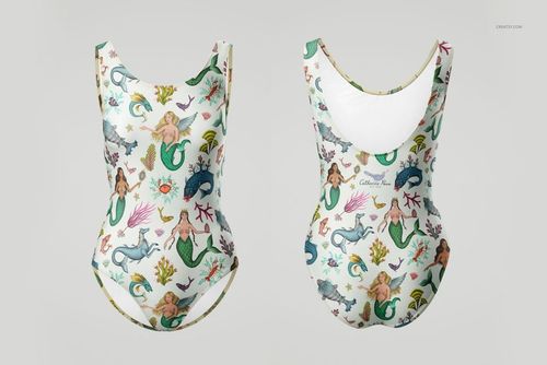PSD mockup showing a swimsuit laid flat, decorated with playful sea creatures and mermaids in vibrant colors.