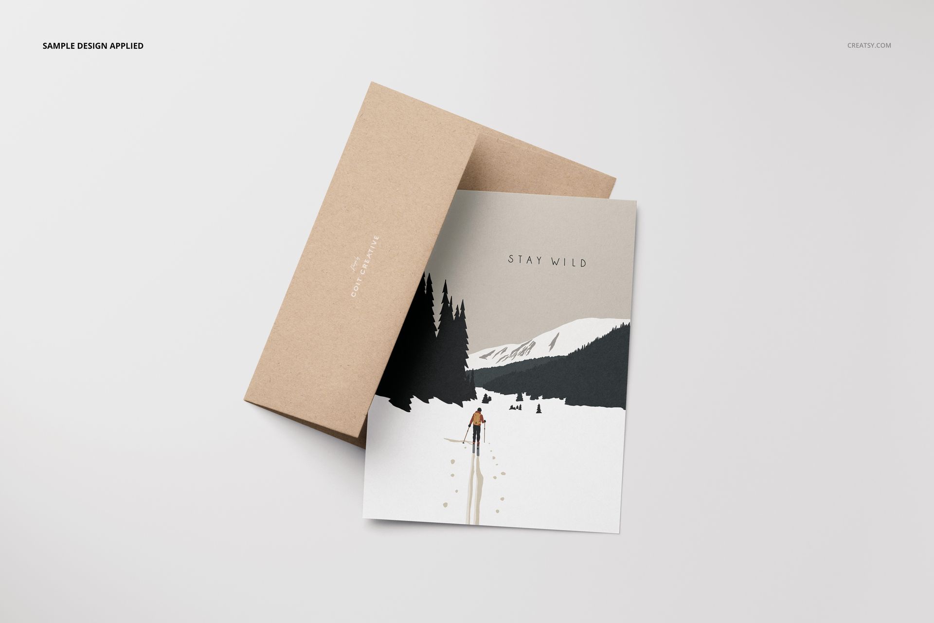A2 card mockup set featuring a brown envelope and a card with a winter landscape illustration, top view.