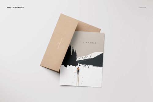 A2 card mockup set featuring a brown envelope and a card with a winter landscape illustration, top view.