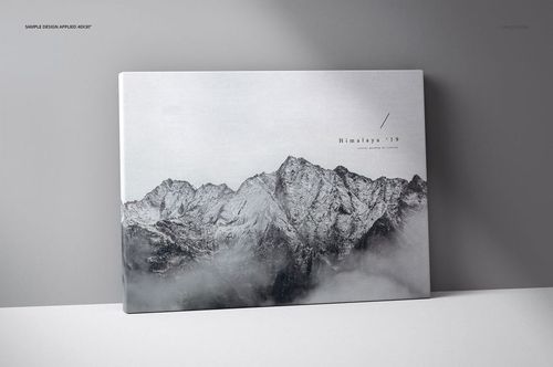 Front view of a thick canvas print mockup featuring a grayscale mountain landscape design, standing against a light gray wall.