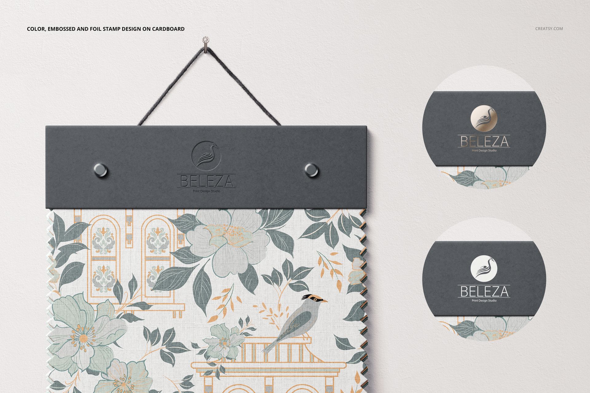 Fabric swatch mockup hanging from a dark gray holder, featuring a floral and bird pattern in soft pastel colors.